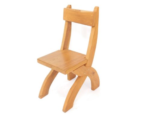 A light oak X frame chair, with solid seat.