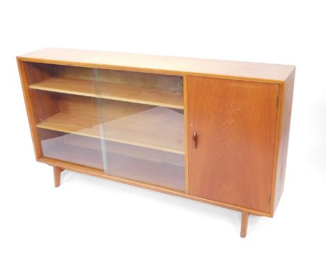 A Herbert E Gibb mid century teak display cabinet, No 5843, with a pair of sliding glazed doors enclosing two shelves, flanke