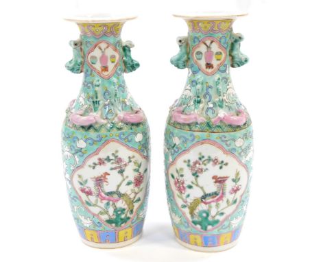 A pair of Chinese Republic 20thC porcelain vases, famille rose decorated with reserves of Ho Ho birds and flowers, moulded wi