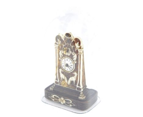 A 19thC continental miniature clock, probably German, circular enamel dial bearing Roman numerals, movement with front suspen