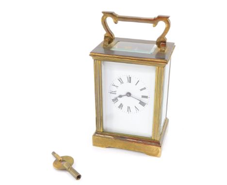 A brass early 20thC carriage clock, enamel dial bearing Roman numerals, the case of conventional form, with key, 12cm high, 8