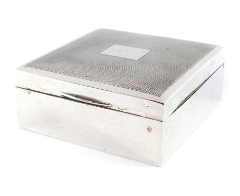 A silver cigarette box, with engine turned decoration, rectangular reserve, Birmingham 1967, 3.5cm high, 8.5cm wide, 8.5cm de