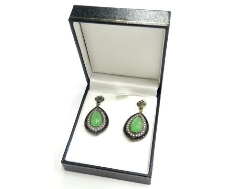 A pair of jade, diamond and onyx drop earrings, each set with central cabochon jade, surrounded by diamonds and onyx with fan