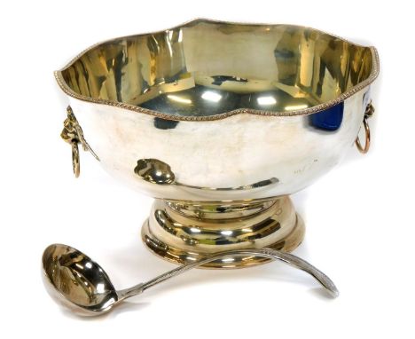 A silver plated pedestal punch bowl, with twin lion's head and ring handles, gadrooned rim, 19cm high, 33cm wide, together wi