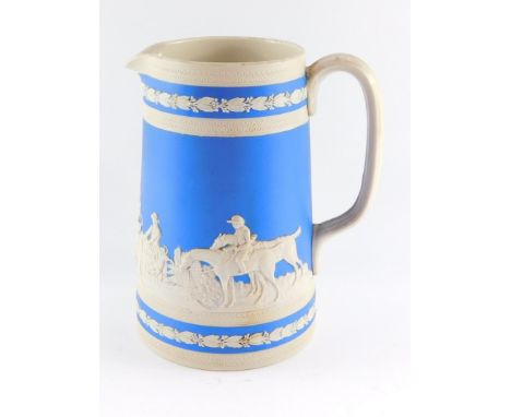 A Copeland Spode late 19thC pottery jug, sprig moulded with hunting figures, against a blue ground, printed mark, 23cm high.