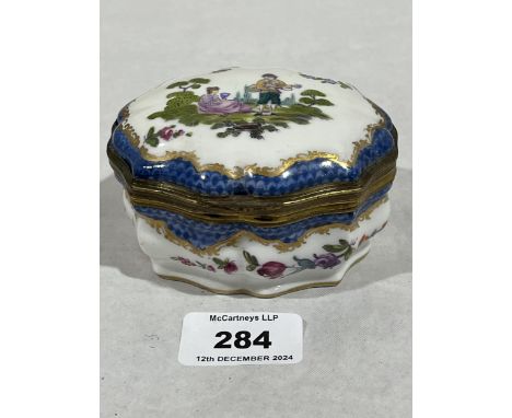 A 19th Century porcelain and gilt metal mounted box painted with lovers in a landscape and flowers on a blue scale ground. 4"