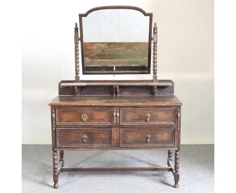 An early 20th century oak dressing chest, on bobbin turned legs, by Maple &amp; Co114w x 49d x 156h cm