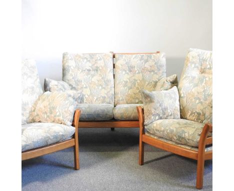 An Ercol light elm three-piece suite, with loose cushions, comprising a sofa, 128cm wide and pair of armchairs (3)128w x 80d 