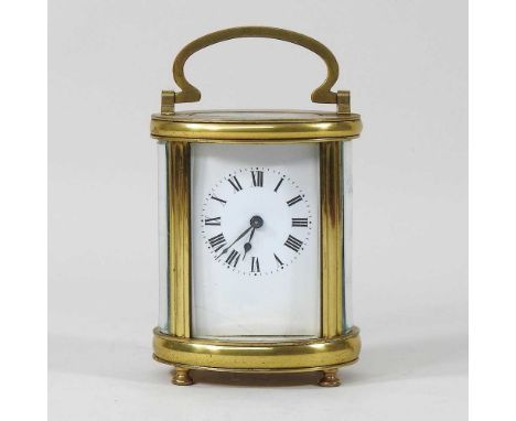 An early 20th century brass oval carriage clock, with a white enamel dial, 16cm highEnamel dial is cracked at the corner, bra