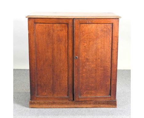 A 19th century oak secretaire cabinet, with a fitted interior, enclosed by a pair of panelled doors. Note: a non-transferable