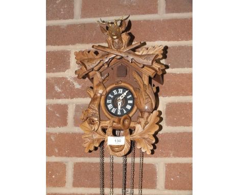 A GERMAN CARVED WOODEN CUCKOO CLOCK