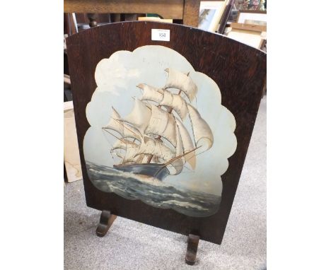 A HAND PAINTED OAK FIRE SCREEN DEPICTING A GALLEON AT SEA