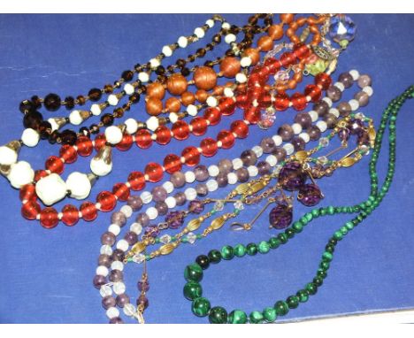 NINE VINTAGE GLASS NECKLACES