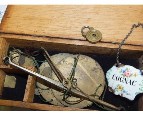 A SET OF ANTIQUE SCALES AND WEIGHTS, WINE LABEL, AND MINIATURE PADLOCK