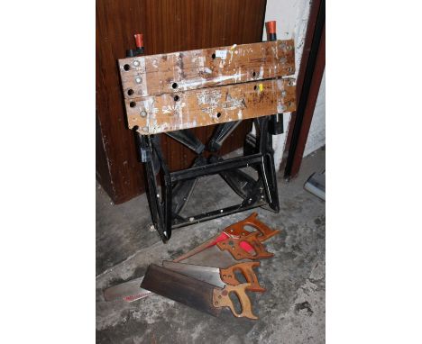 FOUR VINTAGE HAND SAWS TOGETHER WITH A WORK BENCH