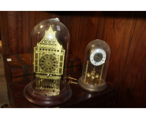 A FRANKLIN MINT GLASS DOMED BRASS MANTEL CLOCK TOGETHER WITH A PLASTIC EXAMPLE