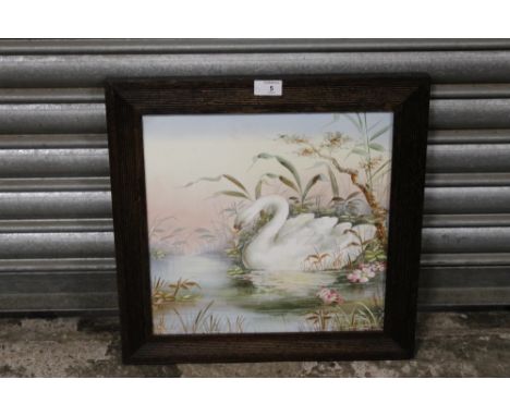 AN OAK FRAMED HAND PAINTED TILE DEPICTING A SWAN, OVERALL SIZE 45 X 45 CM