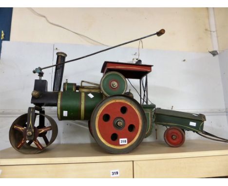 A scratch built floor toy of steam roller and trailer.