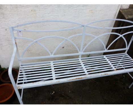 A Victorian painted wrought iron garden bench the reeded openwork frame with double ellipse toprail over an arched trellis ba