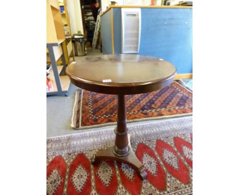 A mid-19th century mahogany tilt-top tripod table with gun barrel column