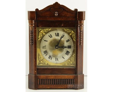 A small oak cased mantel clock, possibly German, the silvered dial with Roman numerals, c1900