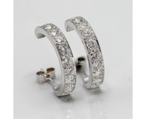 A pair of classic half hoop diamond set earrings, set with 10 modern brilliant cut diamonds stud claw setting. French wire fi