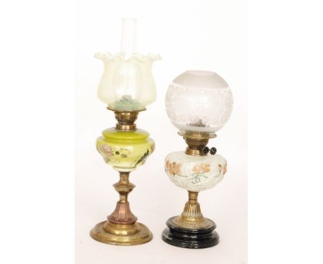 An Edwardian brass oil lamp with vaseline glass shade on circular ribband base, height 53cm, and a similar oil lamp with embo