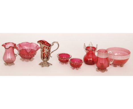 A group of late 19th Century Cranberry glass comprising a cream jug in white metal mounts with floral decoration, a strawberr