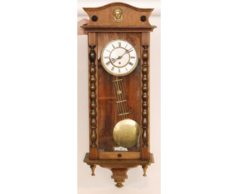 A late 19th Century eight day, sprung driven wall clock, Roman numerals to a white enamelled dial below arched top pediment w