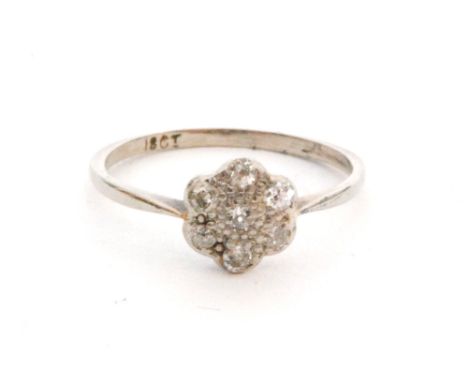 An early 20th Century 18ct white gold diamond daisy cluster ring seven old cut stones to knife edged shoulders, ring size N 1