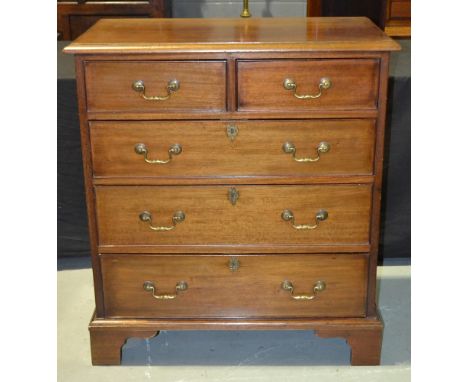 A reproduction mahogany chest of two short over three long drawers in the Georgian style, raised to bracket feet, with cockbe