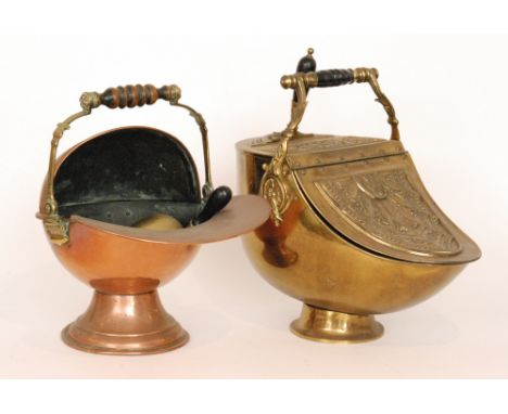 An Edwardian brass fan shaped coal scuttle and shovel and a similar copper helmet shaped coal scuttle. (2)