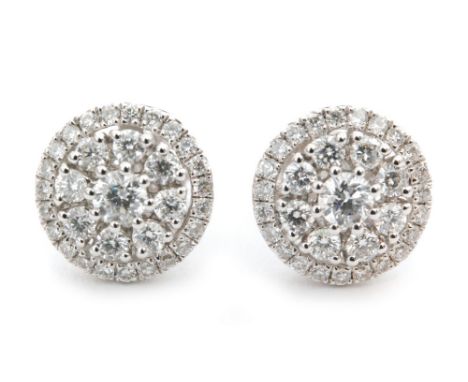 A modern pair of 18ct diamond cluster earrings, round brilliant cut diamond within an eight diamond surround and an outer hal