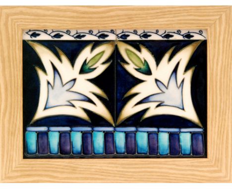 A Moorcroft Pottery framed rectangular panel decorated with two tubelined stylised leaves within patterned border, impressed 