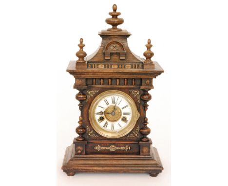 An early 20th Century oak eight day strike mantle clock Roman numerals to a white dial below a pagoda style top, height 43cm.