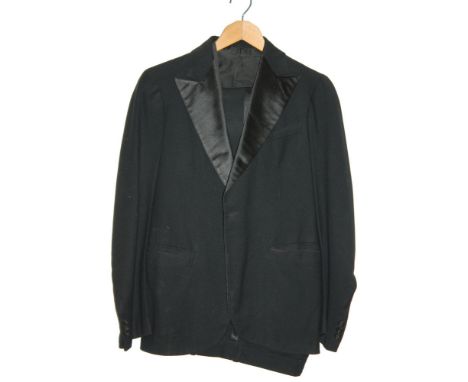 A 1930s gentleman's dress suit comprising dinner jacket, trousers and waistcoat, the jacket labelled Castlerock Clothes, Roos