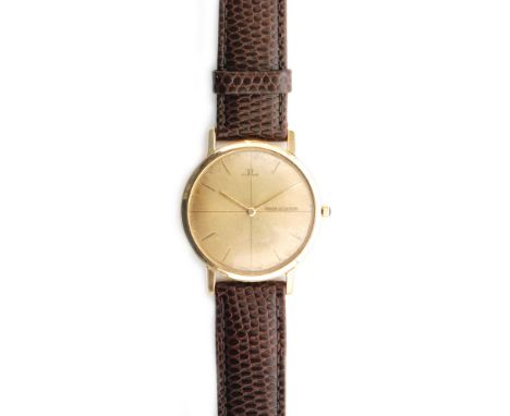 A 1950s 18ct hallmarked gentleman's Jaeger Le Coultre manual wind wrist watch with batons to a champagne circular dial, all t
