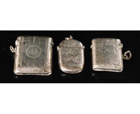 Two hallmarked silver cushioned rectangular vesta cases, one engine turned, the other foliate engraved with a further oval ex