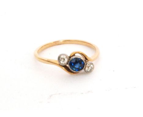 A mid 20th Century sapphire and diamond three stone ring, central sapphire flanked by a diamond, all collar set to a slight t