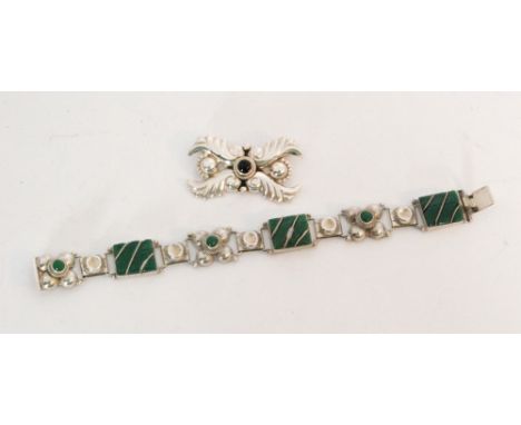A Mexican silver panel link bracelet, green stone rectangular panels space by flower head panels to a tongue and box clasp, s