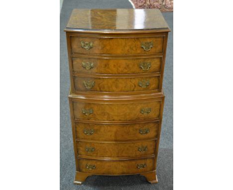 A small Queen Anne style figured bowfront walnut tallboy of seven drawers, brass drop handles on bracket feet, makers tablet 