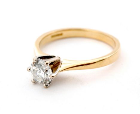 An 18ct solitaire diamond ring, round brilliant cut stone claw set to a plain tapering band, ring size O.