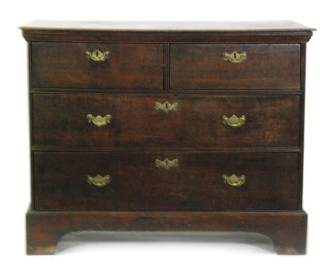 A George III oak straight front chest of two short and two long drawers fitted with brass drop handles, on bracket feet, widt