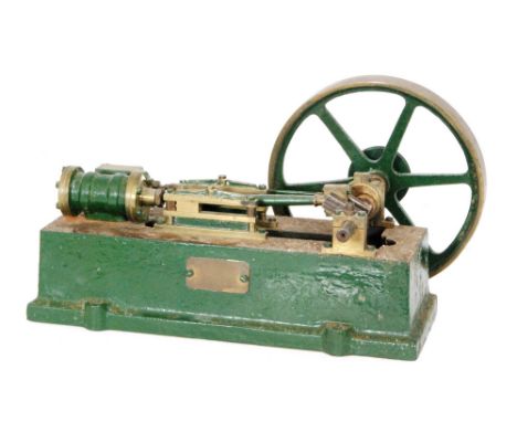 A green painted cast iron model of a steam engine, with single oscillating piston, width 26cm.