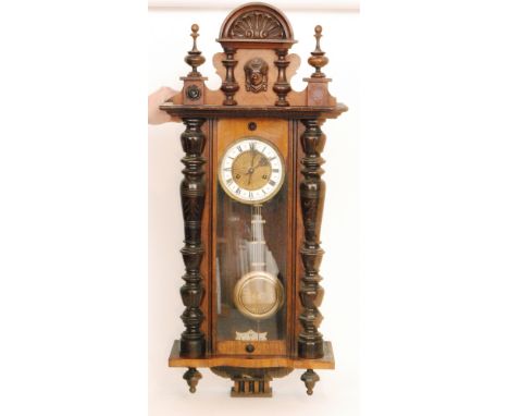 A late 19th Century walnut cased regulator wall clock with spring driven movement enclosed by a glazed door, height 92cm