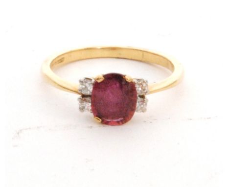 An 18ct hallmarked ruby and diamond ring, central oval ruby flanked with two diamonds to either side, ring size L. 