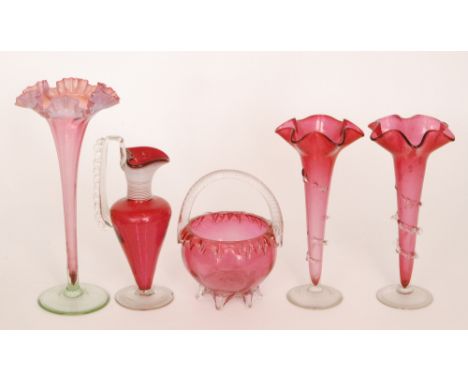 A group of late 19th Century Cranberry glass comprising a pair of trumpet vases each with wave edge rim and applied trailing,