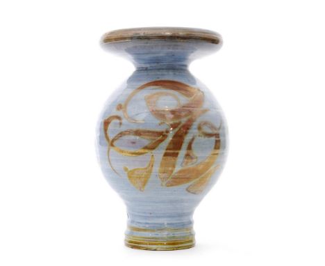 A post war studio pottery Aldermaston vase decorated by Oldrich Asenbryl with lustre painted brush strokes over the blue wash