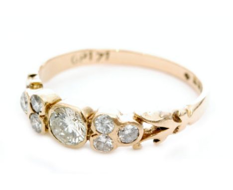 An 18ct hallmarked diamond seven stone ring, central collar set brilliant cut stones flanked by three further diamonds to eac