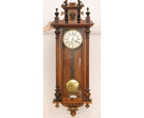 A late 19th Century eight day strike single weight regulator wall clock with Roman numerals to a circular dial behind glazed 